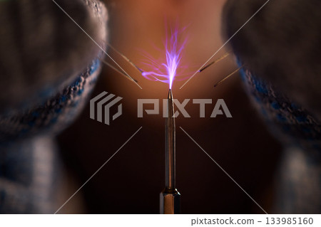 Expert carefully calibrates plasma equipment using sensitive techniques, Research professional employs meticulous methods to adjust plasma probe with expert precision 133985160