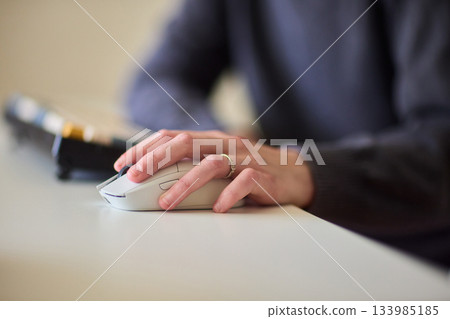Professional hand controls computer, Worker actively managing digital presentation at desk, Business professional guiding mouse during focused digital workflow session 133985185