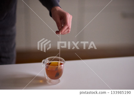Tranquil depiction of tea brewing ritual, Peaceful portrayal of enjoying soothing tea experience, Relaxing scene capturing tranquility of preparing and savoring tea peacefully 133985190