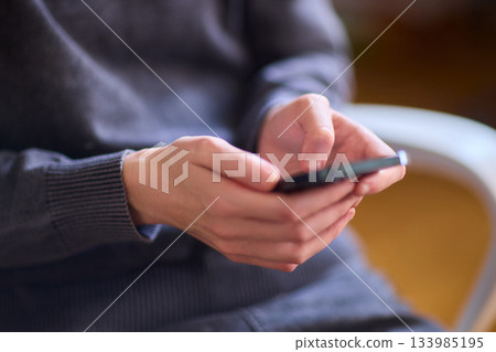 Young lady with cerebral palsy studying using technological aids, Enthusiastic woman with cerebral palsy learning with aid of modern assistive technology at bright workspace 133985195