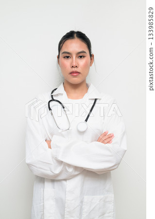 Woman Doctor with Stethoscope in White Uniform on Plain Background Arms Crossed Woman Doctor with Stethoscope in White Uniform on Plain Background Arms Crossed 133985829