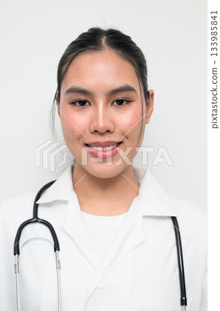 Happy Woman Doctor with Stethoscope in White Uniform on Plain Background Smiling Happy Woman Doctor with Stethoscope in White Uniform on Plain Background Smiling 133985841