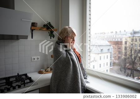 Middle aged woman suffering from seasonal weather changes, having headache and high temperature. Middle aged woman suffering from seasonal weather changes, having headache and high temperature. 133986002