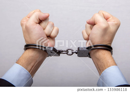 The restriction of freedom, hand, handcuffs, arrest and detention The restriction of freedom, hand, handcuffs, arrest and detention 133986118