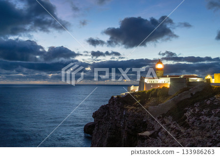 Illuminated Ponta da Piedade Lighthouse and Atlantic Ocean at Evening Twilight. Algarve, Portugal Illuminated Ponta da Piedade Lighthouse and Atlantic Ocean at Evening Twilight. Algarve, Portugal 133986263
