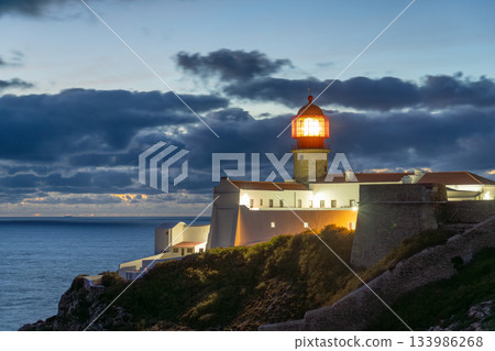 Illuminated Ponta da Piedade Lighthouse and Atlantic Ocean at Evening Twilight. Algarve, Portugal Illuminated Ponta da Piedade Lighthouse and Atlantic Ocean at Evening Twilight. Algarve, Portugal 133986268