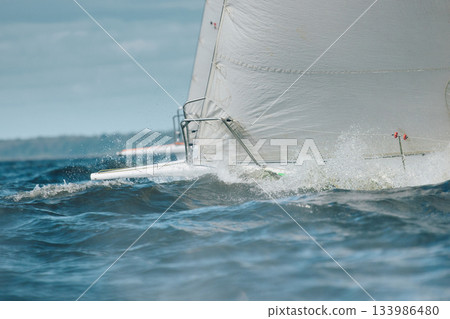 bow of a sailing boat with bowsprit at sailing regatta in the Gulf of Finland at sunny day, sailing yacht competing in a race, splashing water from under the boat, teamwork, board the boat 133986480