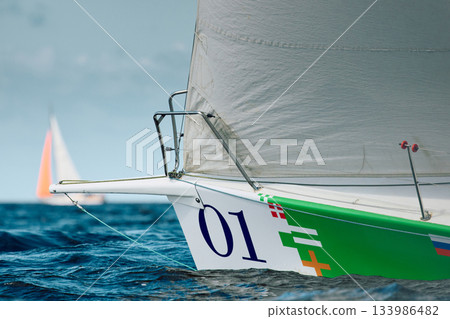 bow of a sailing boat with bowsprit at sailing regatta in the Gulf of Finland at sunny day, sailing yacht competing in a race, splashing water from under the boat, teamwork, board the boat bow of a sailing boat with bowsprit at sailing regatta in the Gulf of Finland at sunny day, sailing yacht competing in a race, splashing water from under the boat, teamwork, board the boat 133986482
