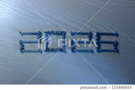 Numbers from hardware form the number 2026 ahead of the New Year. 2026 crafted from metal screws on a wooden surface Numbers from hardware form the number 2026 ahead of the New Year. 2026 crafted from metal screws on a wooden surface 133986955