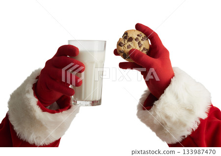 Santa's hands in red gloves holding glass of milk and christmas cookie, left out on christmas eve tradition 133987470