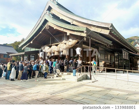 Tourists praying at Izumo Taisha Shrine Tourists praying at Izumo Taisha Shrine 133988801