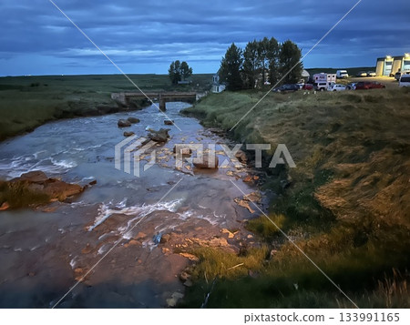 This is a small river and town lights near Hella, a town in southern Iceland. This is a small river and town lights near Hella, a town in southern Iceland. 133991165