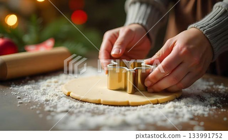 A person rolls out cookie dough with a pastry cutter, embodying the spirit of cozy winter baking during the holiday season 133991752