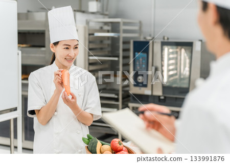 A female instructor who teaches at cooking seminars, vocational schools, and employee training 133991876