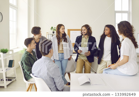 Group of diverse teenage school students and their teacher having discussion in class Group of diverse teenage school students and their teacher having discussion in class 133992649