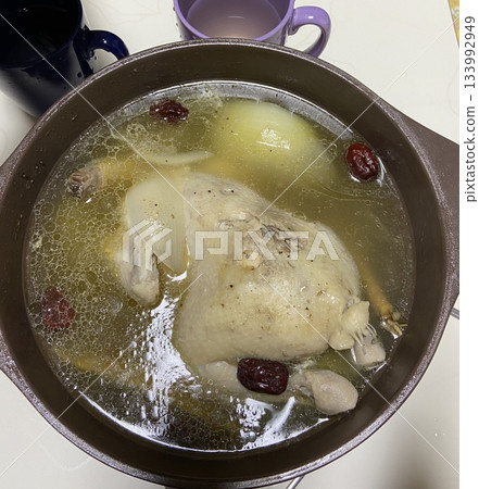 Samgyetang, a hearty Korean ginseng chicken soup, featuring a whole young chicken stuffed with rice, garlic, jujube, and herbs. A nourishing dish perfect for health and comfort. Samgyetang, a hearty Korean ginseng chicken soup, featuring a whole young chicken stuffed with rice, garlic, jujube, and herbs. A nourishing dish perfect for health and comfort. 133992949