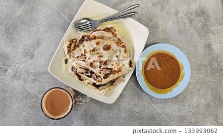 This is a group of food with Roti Canai, Teh Tarik and Curry This is a group of food with Roti Canai, Teh Tarik and Curry 133993062