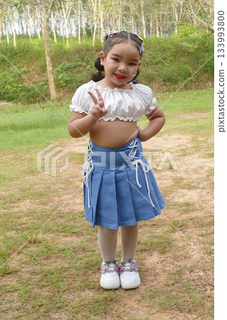 Portrait of little girl in a blue dress in the park Portrait of little girl in a blue dress in the park 133993800
