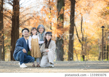 Autumn family photo - Smiling three-generation family portrait in a forest of autumn leaves - Commemorative photo of parents, children and grandmother - Looking at the camera, memories, wide angle Autumn family photo - Smiling three-generation family portrait in a forest of autumn leaves - Commemorative photo of parents, children and grandmother - Looking at the camera, memories, wide angle 133993876