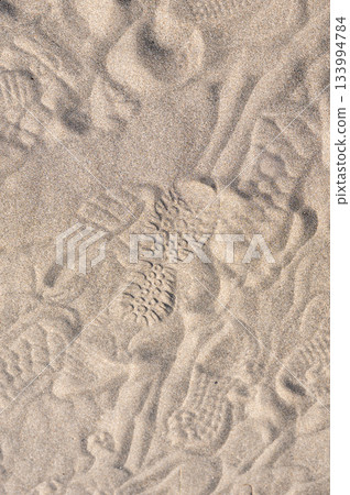 Texture of footprints on the sandy beach 133994784