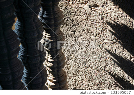 Intricate patterns carved into the exterior walls of a historic building in Cambodia 133995097