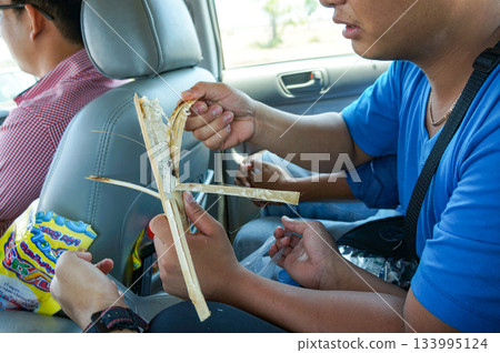 A man eating Cambodian specialty bamboo rice while traveling in a car A man eating Cambodian specialty bamboo rice while traveling in a car 133995124