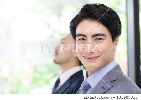 Close-up of multiple business scenes of two office workers standing side by side in fresh green or green suits looking up ahead Close-up of multiple business scenes of two office workers standing side by side in fresh green or green suits looking up ahead 133995313