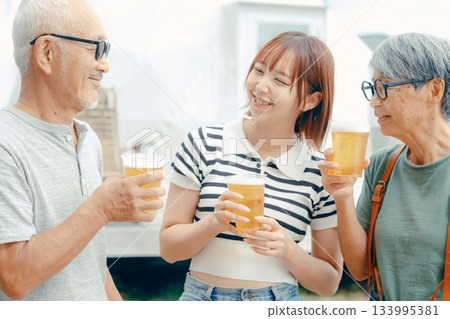 三個人站在海灘上舉杯慶祝的場景 133995381