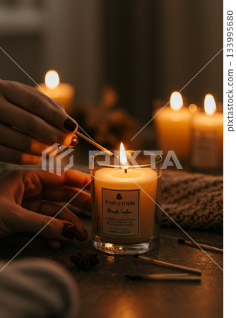 Woman Lighting Aromatic Candle with Match 133995680