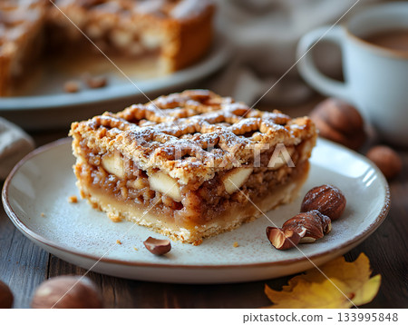 Slice of Warm Homemade Apple Pie with Lattice Crust and Powdered Sugar 133995848