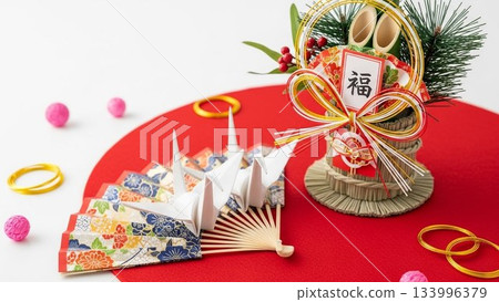 New Year's image material with a red background, a fan and New Year's decorations, and a blank space above New Year's image material with a red background, a fan and New Year's decorations, and a blank space above 133996379