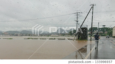Flooding damage caused by heavy rain in Takeo City, Saga Prefecture. Flooded roads and fields. Flooding damage caused by heavy rain in Takeo City, Saga Prefecture. Flooded roads and fields. 133996937