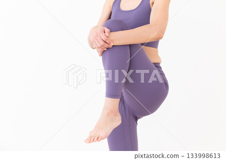 一位身穿瑜珈服的中年婦女正在做伸展運動 133998613