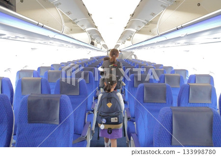 Family boarding an airplane 133998780