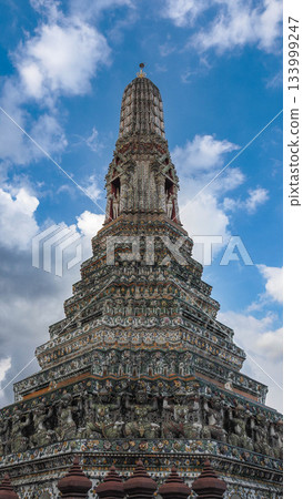 The Central Prang of Wat Arun (Temple of Dawn) in Bangkok, Thailand, against a Blue Sky The Central Prang of Wat Arun (Temple of Dawn) in Bangkok, Thailand, against a Blue Sky 133999247