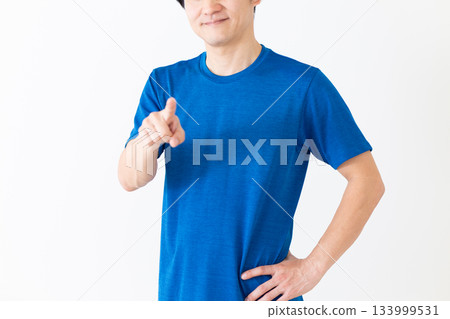 A middle-aged man wearing a T-shirt and pointing A middle-aged man wearing a T-shirt and pointing 133999531