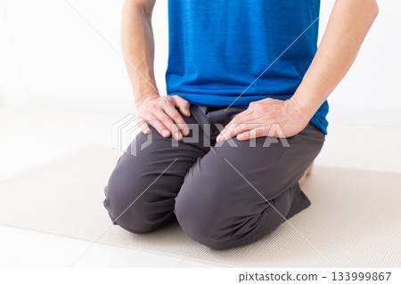 A middle-aged man in a T-shirt sitting in seiza position A middle-aged man in a T-shirt sitting in seiza position 133999867
