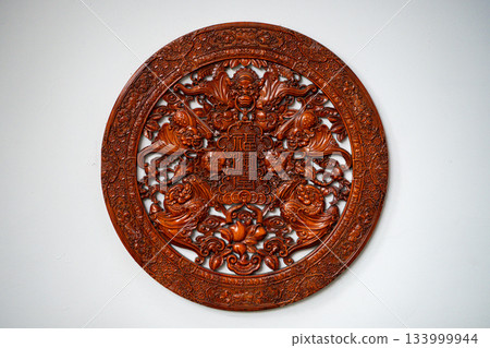 Intricate wooden wall decor showcasing traditional artistry Intricate wooden wall decor showcasing traditional artistry 133999944