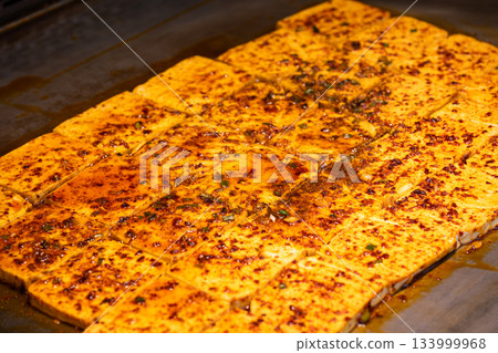 Delicious Sichuan-style grilled tofu during dinner service Delicious Sichuan-style grilled tofu during dinner service 133999968