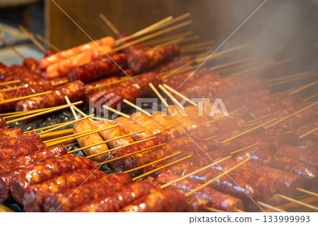 Grilled skewers of meat at a night market Grilled skewers of meat at a night market 133999993