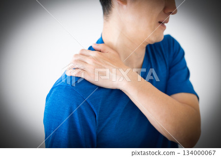 A middle-aged man wearing a T-shirt suffering from stiff shoulders A middle-aged man wearing a T-shirt suffering from stiff shoulders 134000067