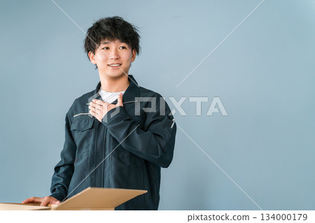 Male and female transportation, logistics, courier, distribution, delivery, and delivery workers packing items into cardboard boxes 134000179