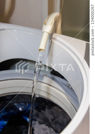 A hose that pumps water from the bathtub to the washing machine A hose that pumps water from the bathtub to the washing machine 134000267