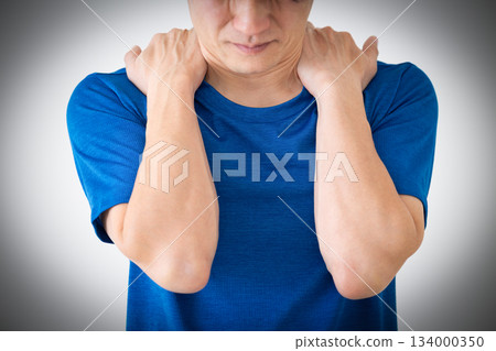 A middle-aged man wearing a T-shirt suffering from stiff shoulders A middle-aged man wearing a T-shirt suffering from stiff shoulders 134000350