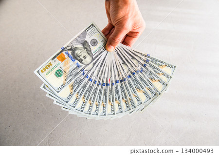 A wide shot of 18 US $100 bills fanned out and presented from the back A wide shot of 18 US $100 bills fanned out and presented from the back 134000493