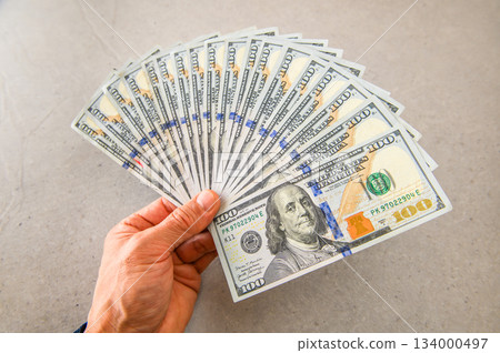 Angled shot 2 of 18 cards fanned out in the left hand and presented to the left 134000497