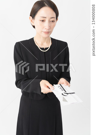 Woman in mourning clothes Funeral image 134000808