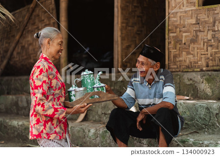 A Warm and Heartfelt Exchange Occurs Between an Elderly Couple in a Traditional Setting 134000923