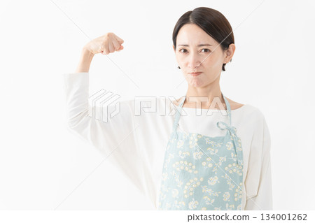Woman wearing an apron Lifestyle image Woman wearing an apron Lifestyle image 134001262