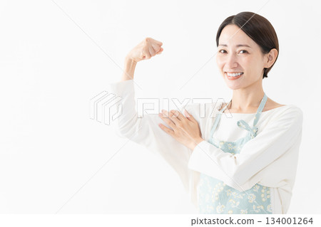 Woman wearing an apron Lifestyle image Woman wearing an apron Lifestyle image 134001264